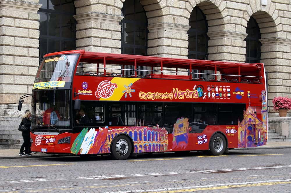 Verona, Italy - Unknown and unidentifiable participants entering a Red Güleryüz panorama double decker sightings tourist bus in the city of Verona.