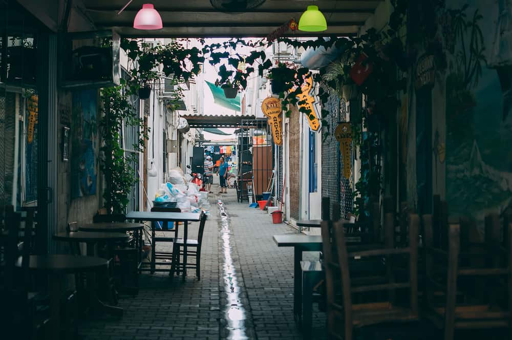 Turkey, Turgutreis - A small street near the local bazaar, where 2 local residents argue, a small resort town near Bodrum
