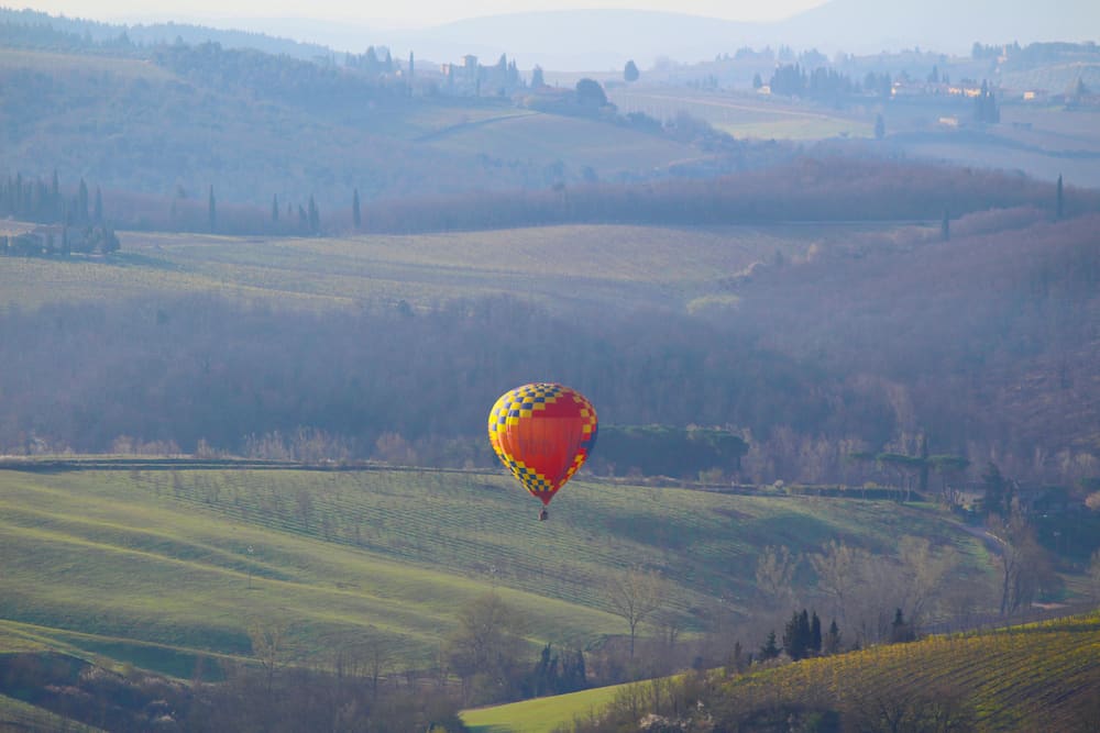 A hot air balloon at sunrise above the Chianti hills south of Florence in Tuscany