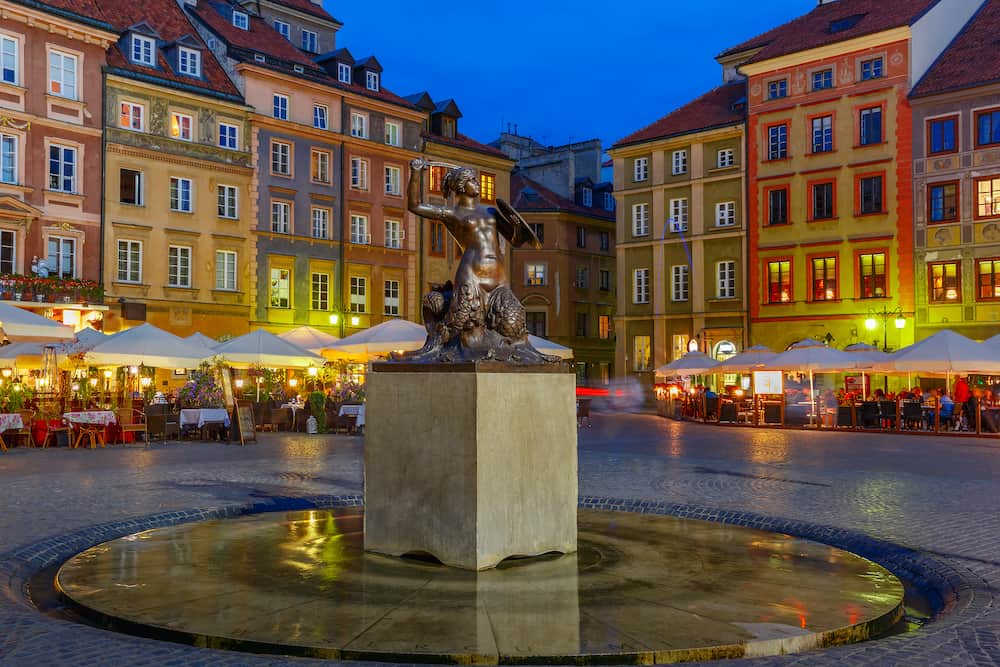 Statue of Syrenka, Mermaid of Warsaw, symbol of the city of Warsaw, at the Old Town Market Square at night, Poland
