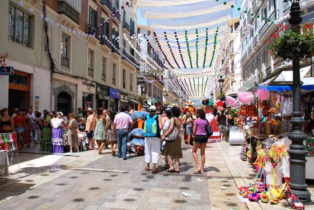 MALAGA, SPAIN - People enjoying the festivities along Calle Marques de Larios at the Feria de Malaga, Malaga, Spain