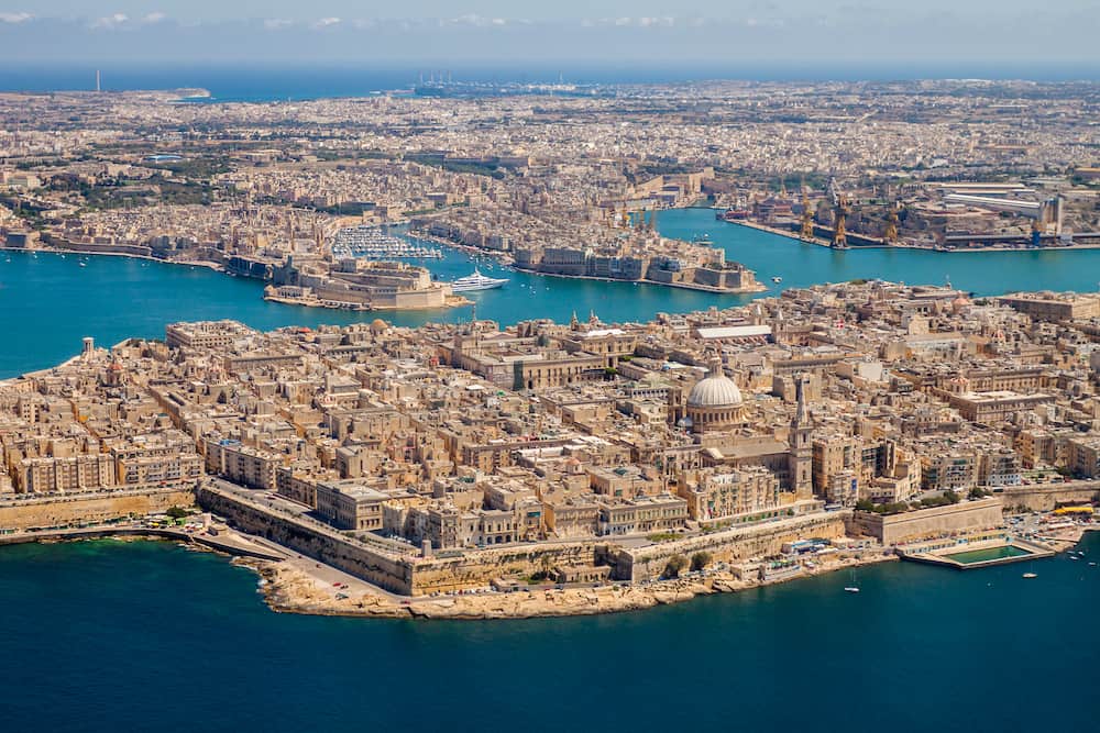 Malta aerial view. Valetta, capital city of Malta, Grand Harbour, Senglea and Il-Birgu or Vittoriosa towns, Fort Ricasoli and Fort Saint Elmo from above. Marsaxlokk city and Freeport in background.