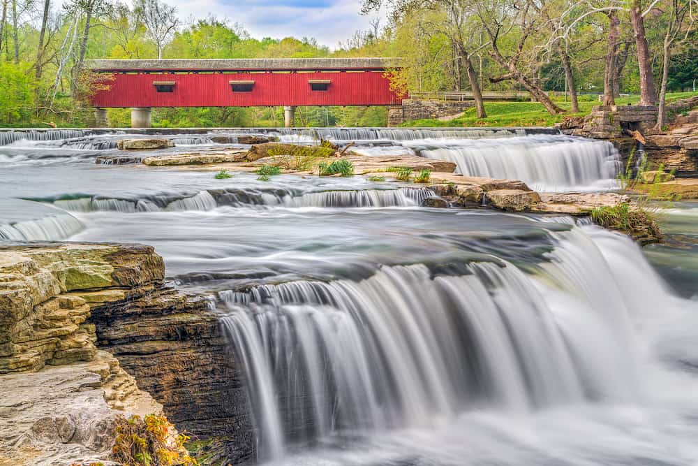 The historic red Cataract Covered Bridge crosses Indiana's Mill Creek just upstream from Upper Cataract Falls in northern Owen County not far from the town of Cloverdale.