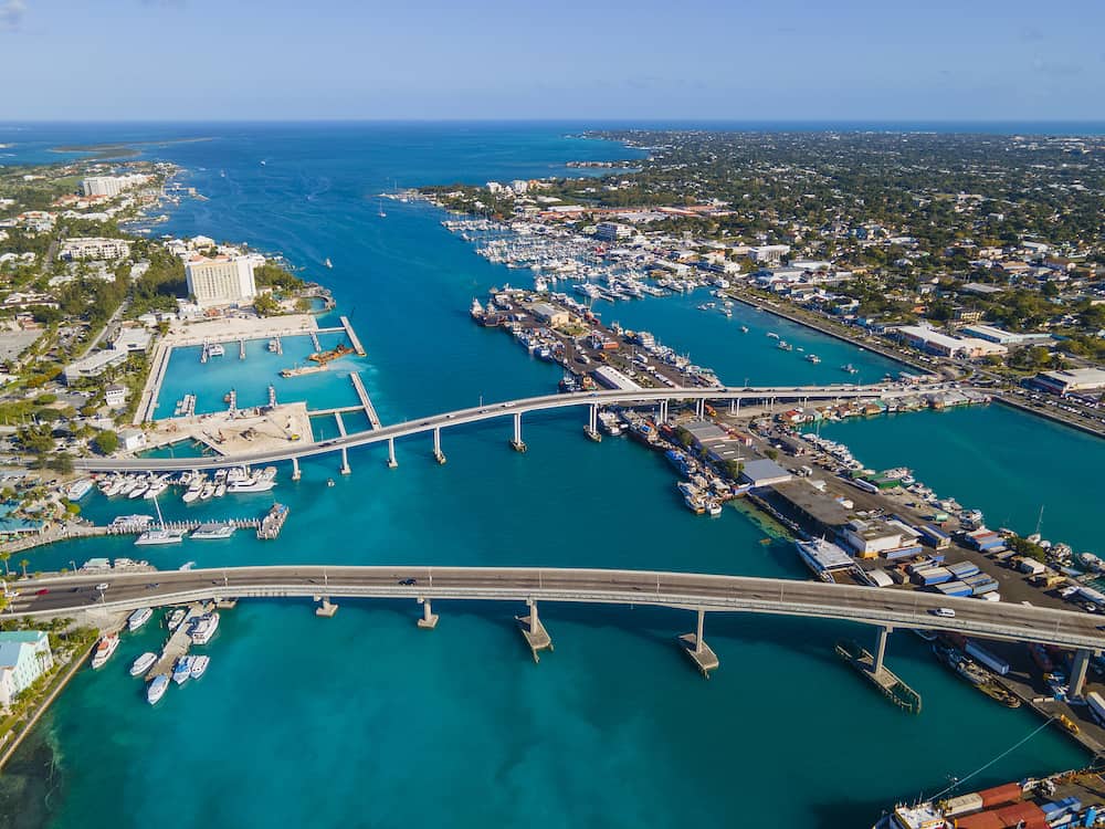 Nassau downtown aerial view including Paradise Island Bridge and Potters Cay in Nassau Harbour, New Providence Island, Bahamas.