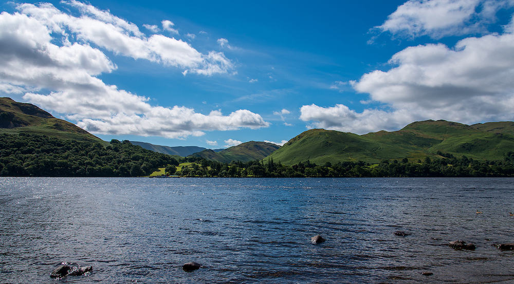 A view across Ullswater in the Lake District in Cumbria with the lake in the foreground