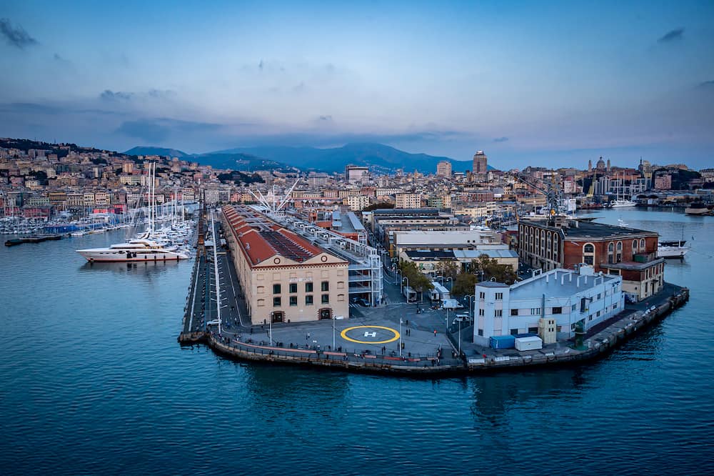 GENOA, ITALY -Congress Centre in Genoa historic cotton warehouses in the Old Port in Genova, Italy. Sea view and yachts at sunset.