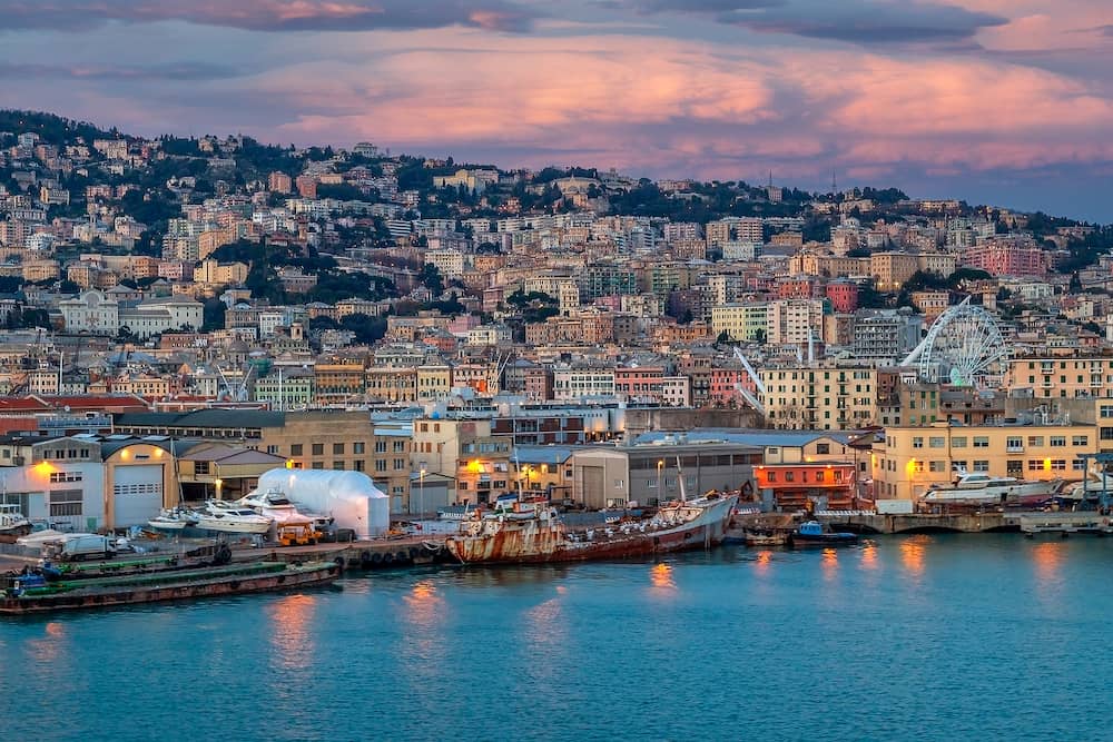 GENOA, ITALY - Panoramic view of port of Genoa with colorful houses on italian coastline. Afternoon lights.