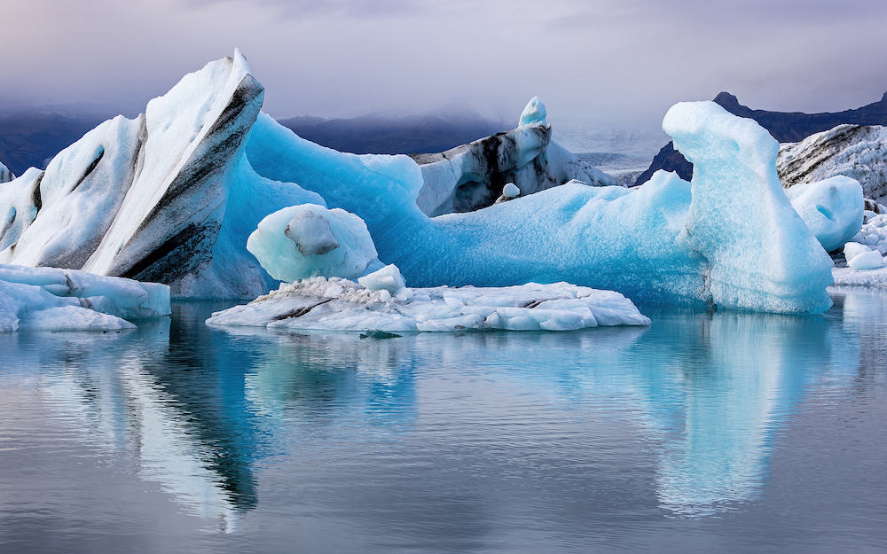 Beautiful blue icebergs reflected in the Jokulsarlon glacial lagoon, Southern Iceland. Part of the Vatnajokull National Park and Vatnajokull glacier, the largest glacier in Europe.