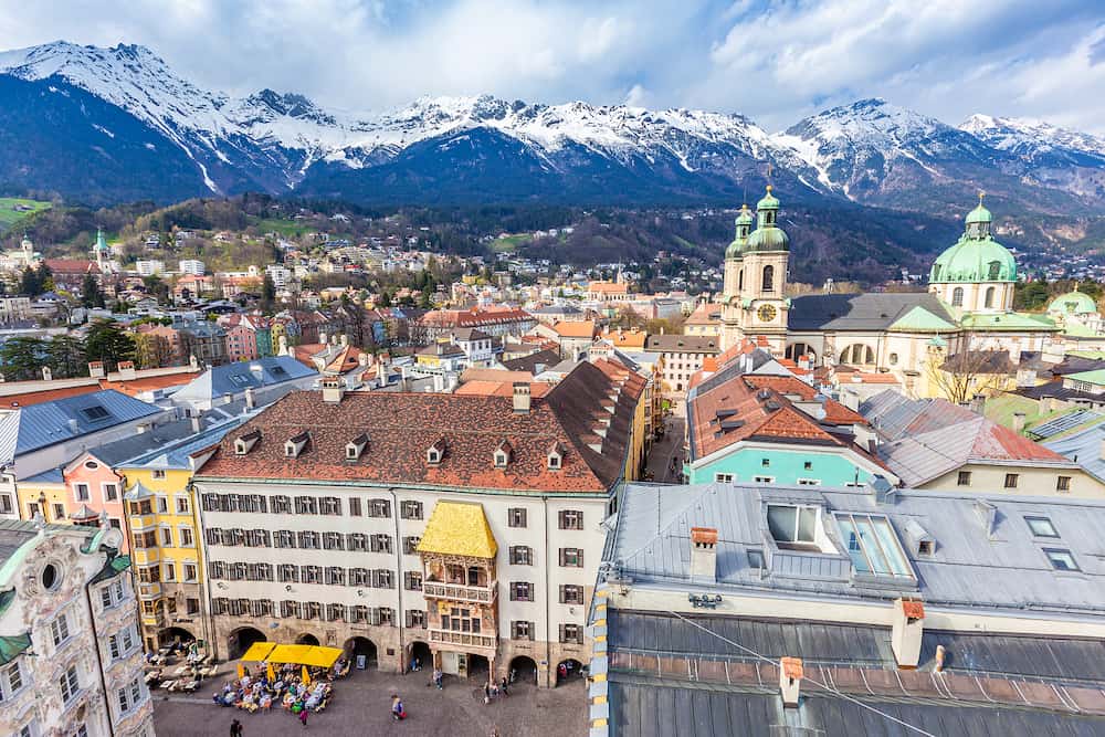 Innsbruck, Austria - Aerial view of Innsbruck old town shows the famous Goldenes Dachi and beatiful snow mountain ranges in the background