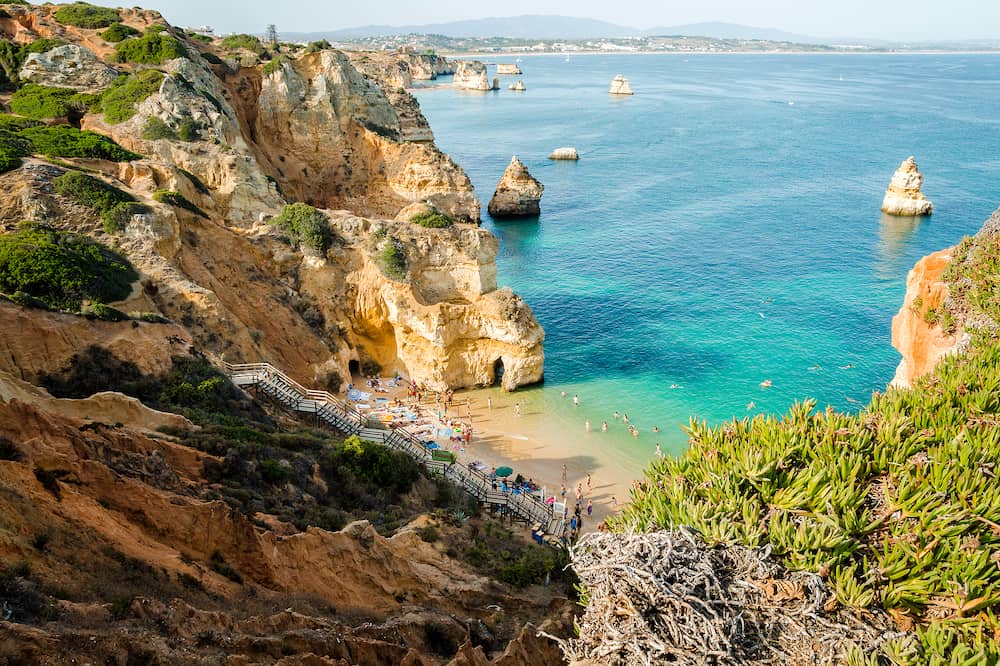 Camilo Beach in Lagos, Algarve, Portugal. A tiny secret beach between the limestone walls.