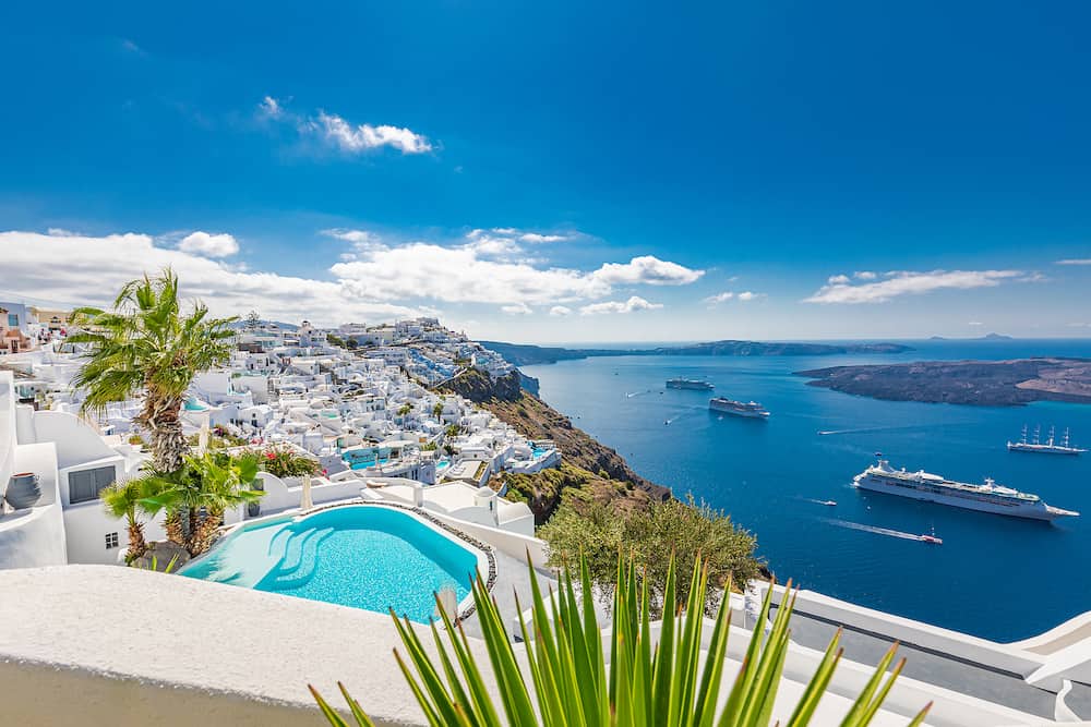 Fira, Oia, Santorini - Luxury travel vacation landscape with infinity pool, swimming pool with sea view. White architecture on Santorini island, Greece. Beautiful landscape with sea view