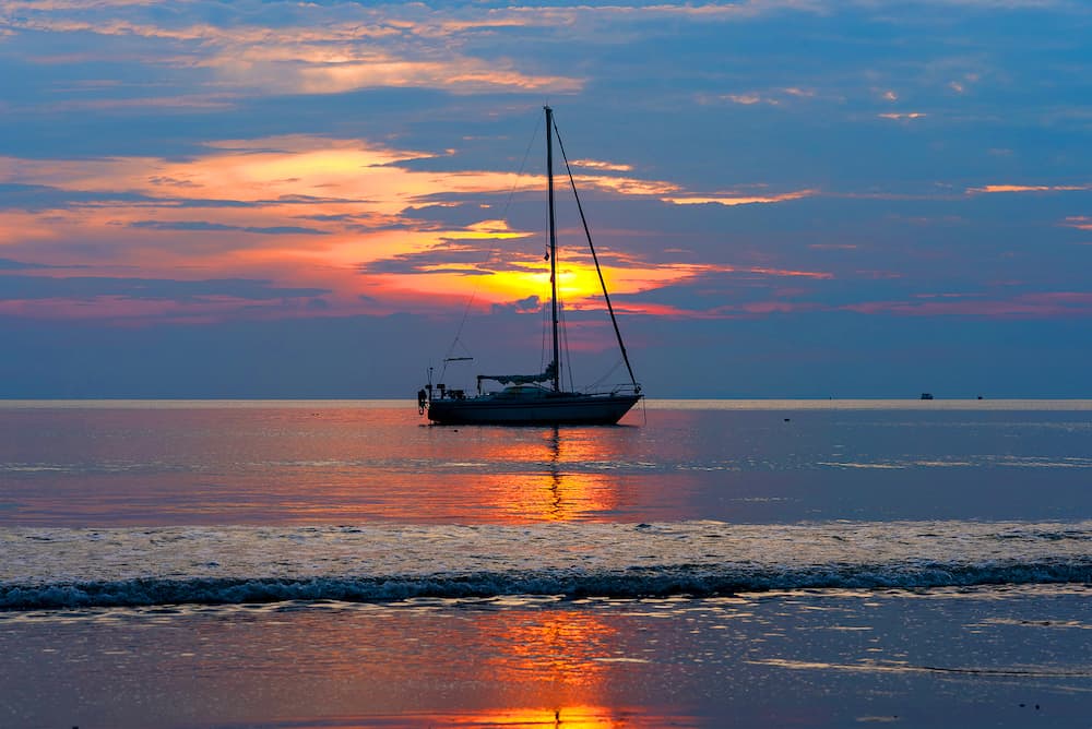 Sailing boat on the sea at sunset. Beautiful sunset at the sea with boats