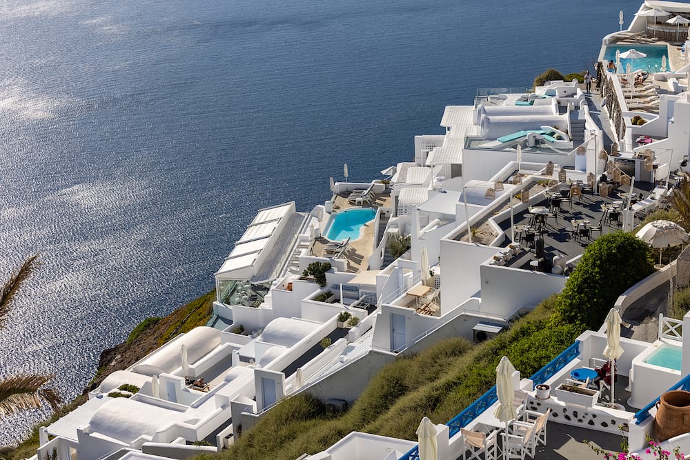 Imerovigli, Santorini, Greece - Whitewashed houses with terraces and pools and a beautiful view in Imerovigli on Santorini island, Greece