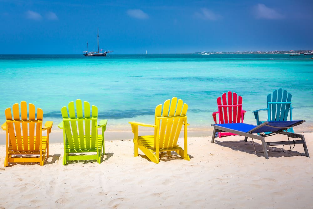Colorful chairs and Caribbean beach with pirate ship, Aruba