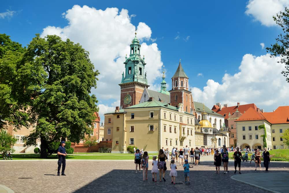 KRAKOW, POLAND - The Wawel Royal Castle, a castle residency located in central Krakow. Tourists exploring the Wawel Hill, the most historically and culturally important site in Poland.