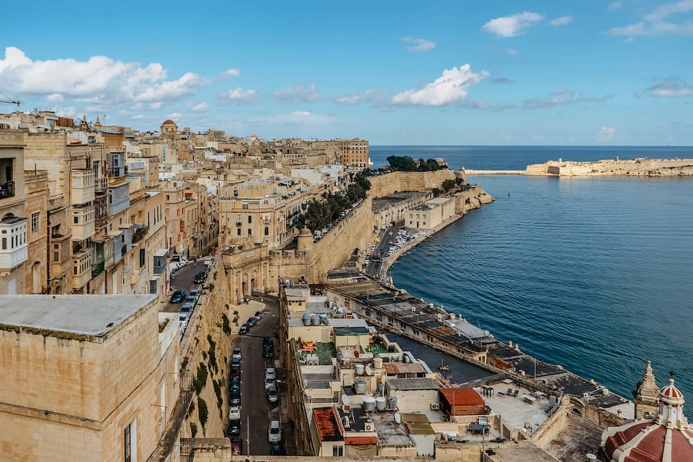 Panoramic view of Valletta,Malta.City skyline from Upper Barrakka Gardens.Beautiful cityscape,sunny summer day.Waterfront stone houses with colorful balconies.Ideal spot for European vacation by sea.