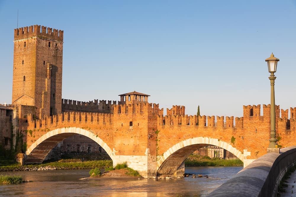 Verona, Italy. Castelvecchio bridge on Adige river. Old castle sightseeing at sunrise
