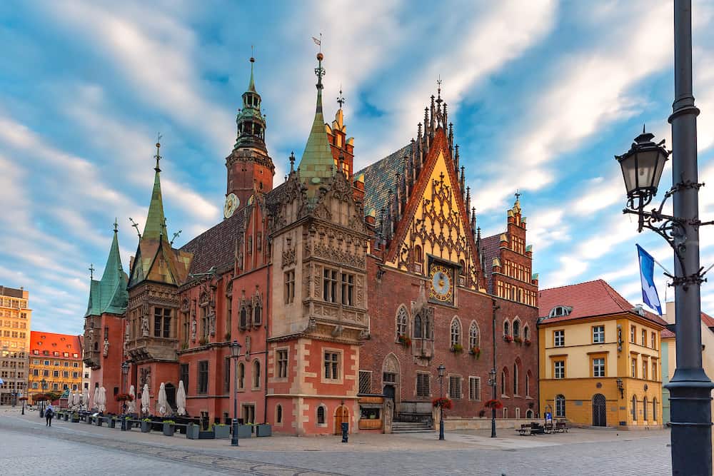 Multicolored traditional historical houses and City Hall on Market square at sunset, Old Town of Wroclaw, Poland