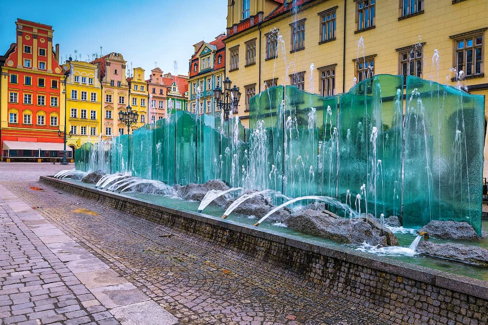 Picturesque city center with beautiful glass fountain and colorful houses on the Market Square, Wroclaw, Poland, Europe