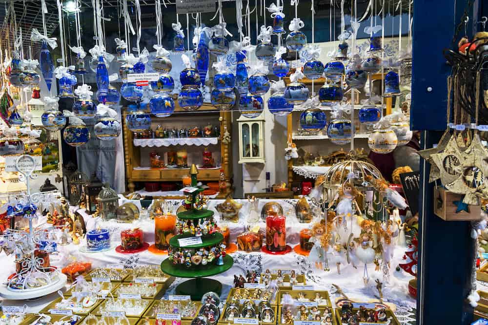 Austria-Linz - Hand crafted artisan blue white crystal golden and silver painted glass balls decorations ornaments hanging at Christmas market in European city. Festive atmosphere