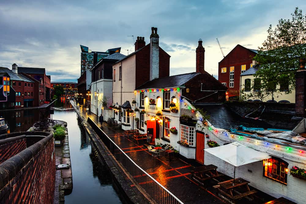 Birmingham, UK. Embankments during the rain in the evening at famous Birmingham canal in UK. Cloudy blue sky at night