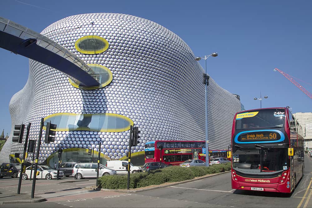 Birmingham, UK: Street view of Selfridges Department Store in Park Street - part of the Bullring Shopping Centre. A double-decker bus is stopped at the traffic lights.