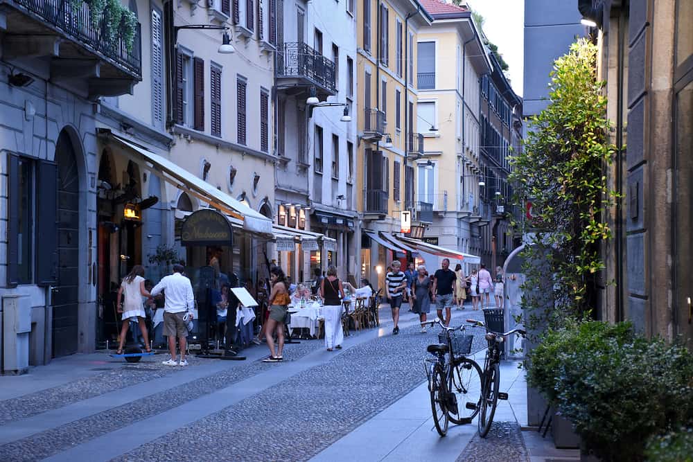 Milan, Italy. Beautiful, lovely, romantic streets of Brera with traditional, Italian restaurants with good food and wines. Tourists, local people are having aperitivo or dinner there