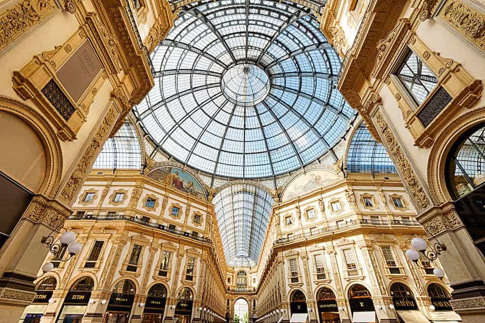 Milan, Italy - Inside the Galleria Vittorio Emanuele II in Milano. This gallery is one of the world`s oldest shopping malls and Milan landmark. Luxury interior of the Milan architecture.