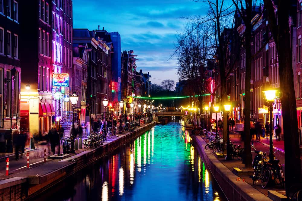 Night view of Red - light district in Amsterdam, Netherlands with sex shops