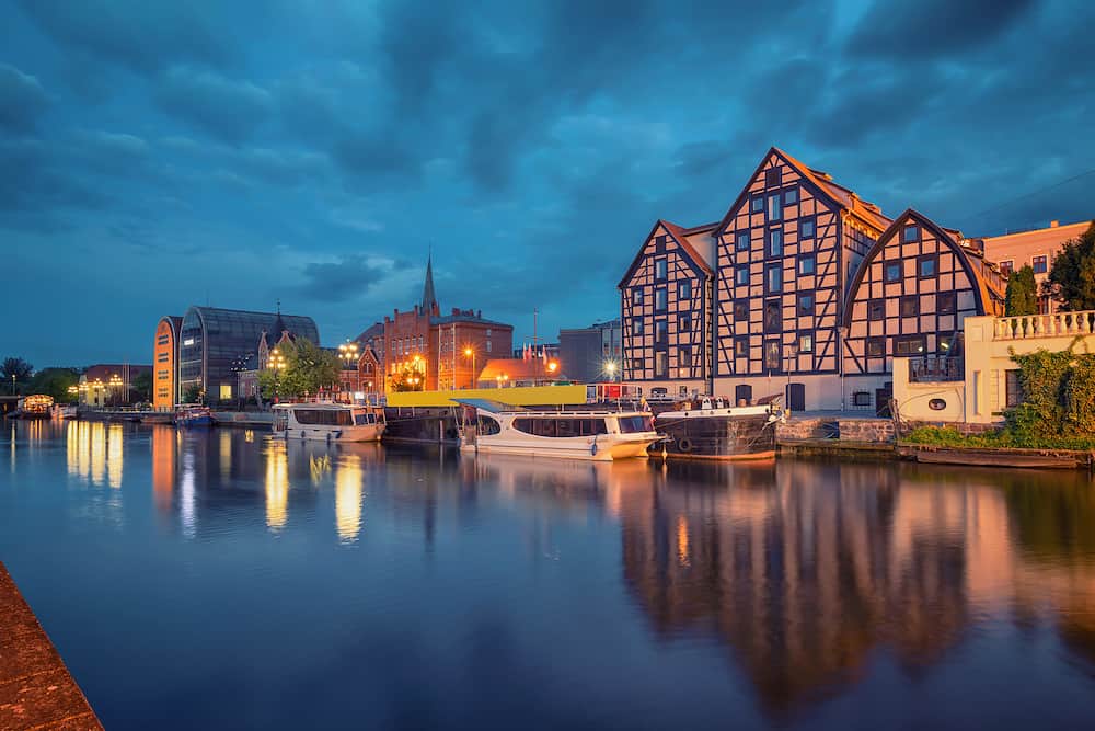 Bydgoszcz, Poland. View of old half-timbered buildings on embankment of Brda river at dusk