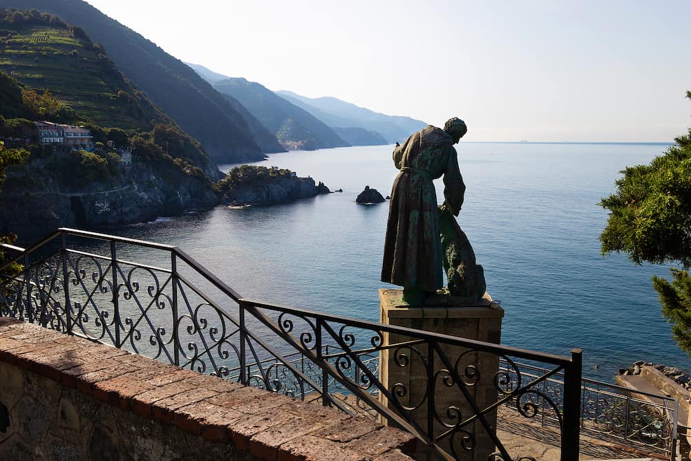 Panoramic coastel veiw with the Statue of St. Francis of Assisi with the wolf at Monterosso Al Mare in Cinque Terre, Liguria, Italy.