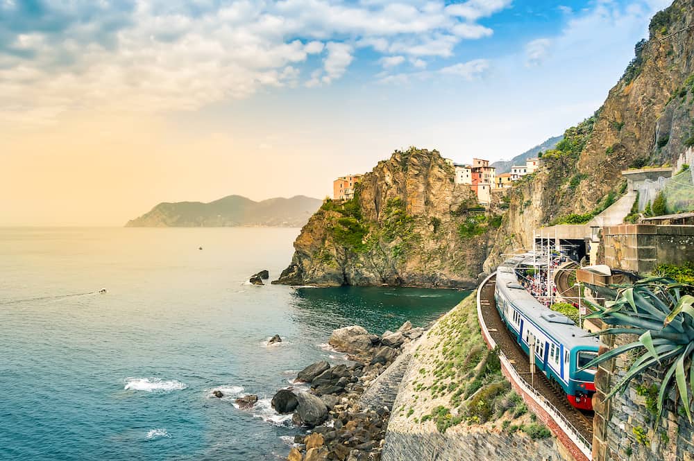 Manarola, Cinque Terre - train station in small village with colorful houses on cliff overlooking sea. Cinque Terre National Park with rugged coastline is famous tourist destination in Liguria, Italy