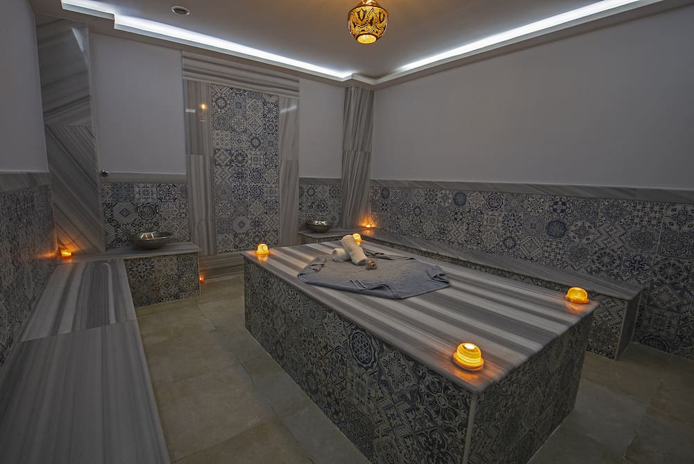 Interior design of turkish baths in luxury health spa with massage table and candles