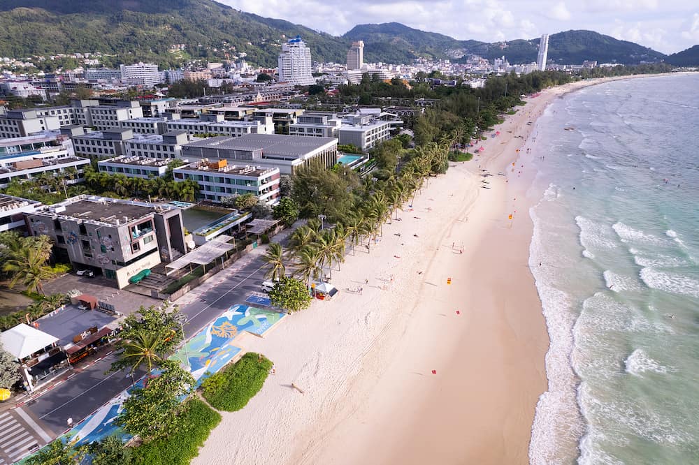 Aerial view of amazing beach with people relax on the beach sea, Beautiful Patong beach Phuket Thailand, Amazing sea beach sand tourist travel destination in andaman sea, Travel and tour concept