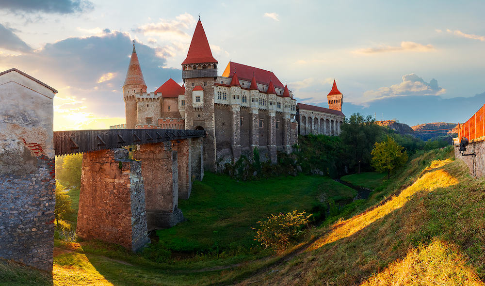 hunedoara, romania - corvin castle at sunrise. panoramic view of medieval fortification in morning light. one of the most beautiful landmarks in transylvania. popular travel destination