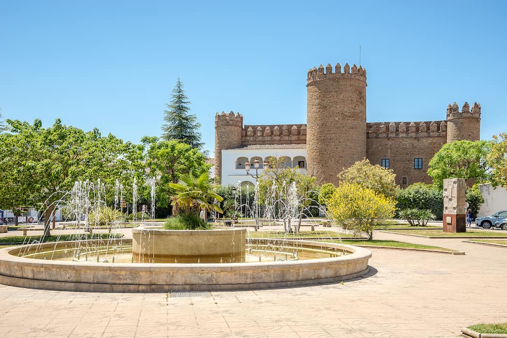 ZAFRA,SPAIN - View at the fountain with Zafra Castle in Spain. Zafra is a town situated in the Province of Badajoz in Extremadura of Spain.