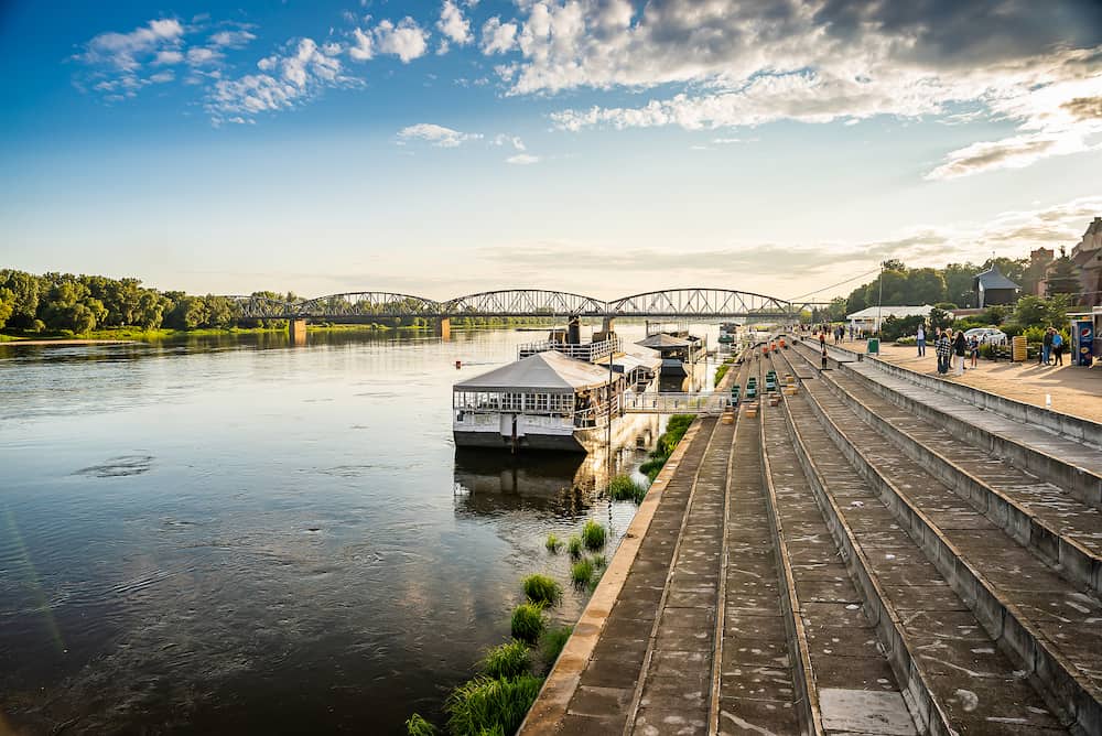 Torun, Poland - Panoramic view of Wisla river with river bank in sunset