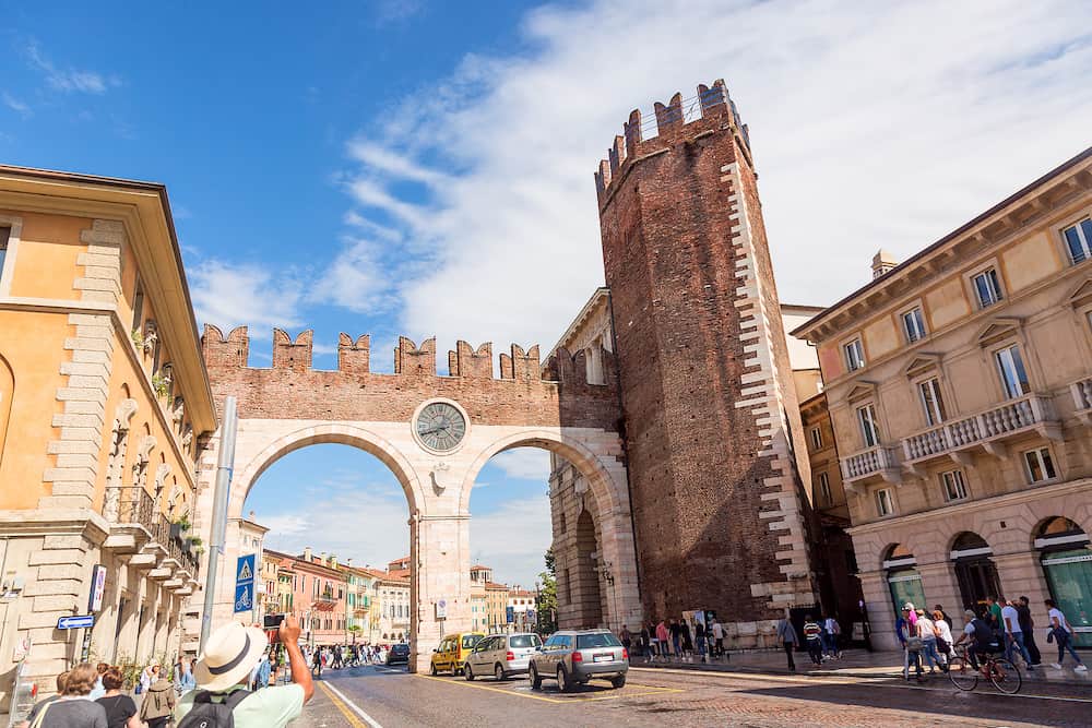 Verona, Italy - Medieval Porta Nuova, gate to the old town of Verona with tourists. Piazza Bra in Verona. Veneto region, Italy. Summer sunny day.