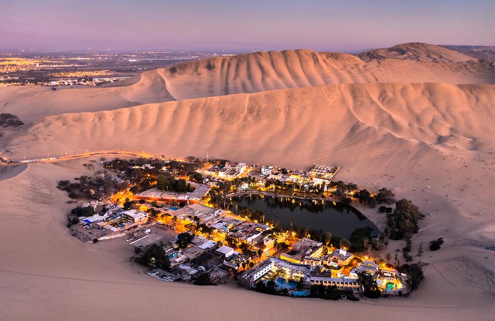 Aerial sunset view of the Huacachina Oasis in Peru