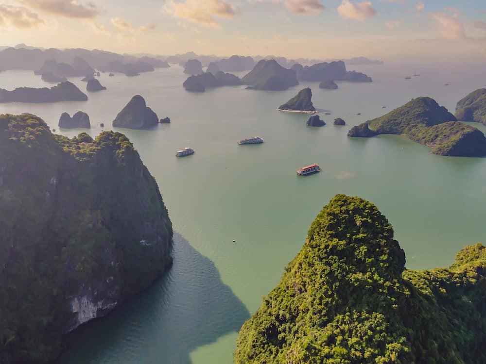 Aerial view panorama of floating fishing village and rock island, Halong Bay, Vietnam, Southeast Asia. UNESCO World Heritage Site. Junk boat cruise to Ha Long Bay. Popular landmark of Vietnam