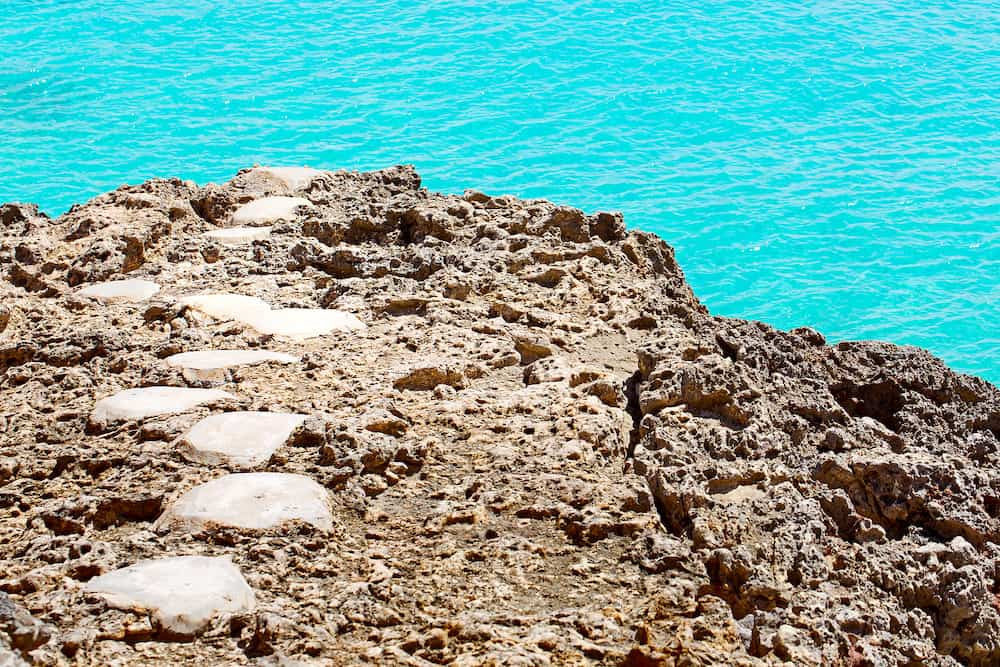 stone path at rocky shore at tropical beautiful island with turquoise water