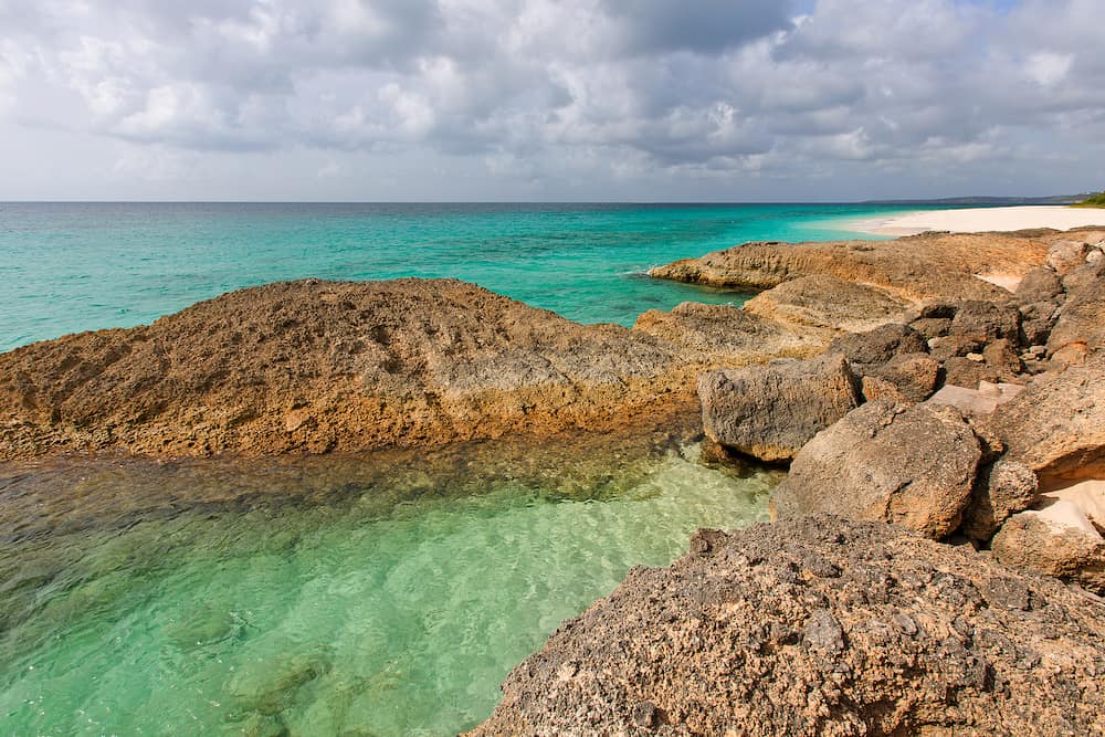 view at beautiful rocky white sand beach and turquoise lagoon at anguilla island caribbean
