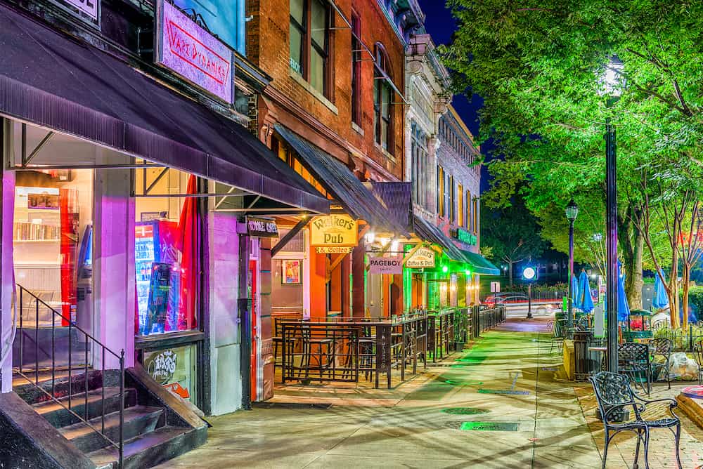 ATHENS, GEORGIA - Shops and bars along College Avenue in downtown Athens at night.