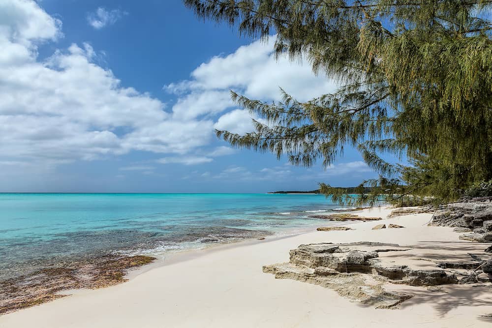 A beautiful bay with turquoise water and a rocky shoreline in the Orange Creek area of Cat Island, Bahamas.