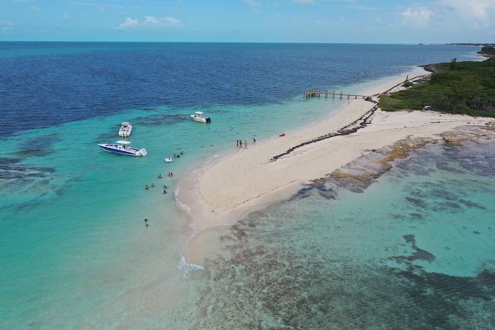 Aerial view of boats anchored in Honeymoon Harbour near Gun Cay and Bimini, Bahamas on sunny summer afternoon.