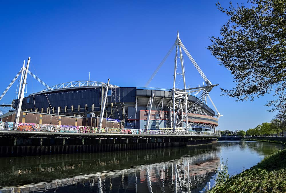 Cardiff, United Kingdom. Exterior of Cardiff Millennium Stadium with the reflection on River Taff in a sunny day.
