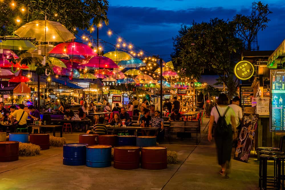 Chiang Mai, Thailand; Unidentified people eating and relaxing at night bazaar.