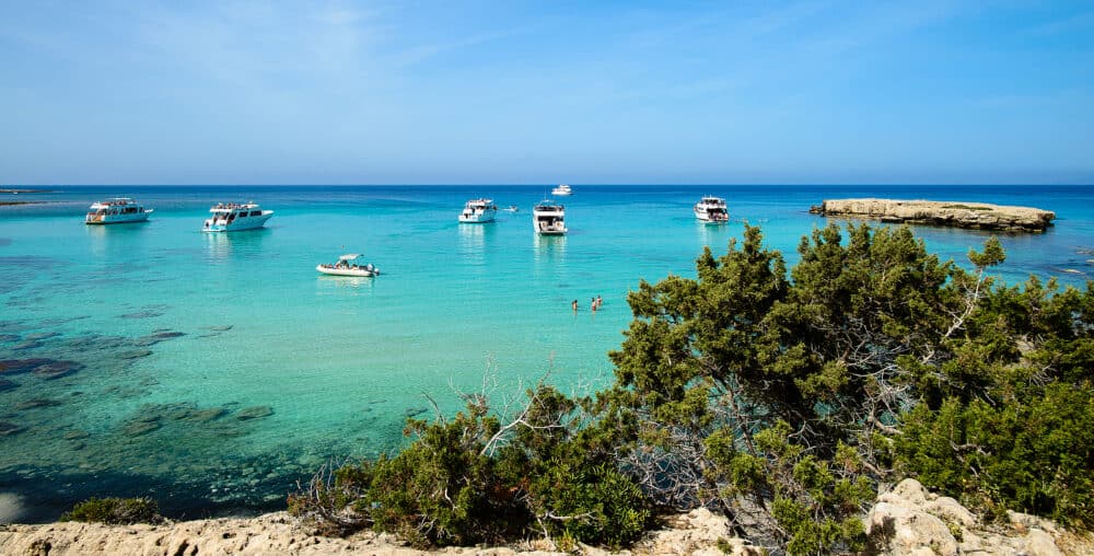 Tourist boats are mooring at Blue lagoon at Akamas peninsula on Cyprus