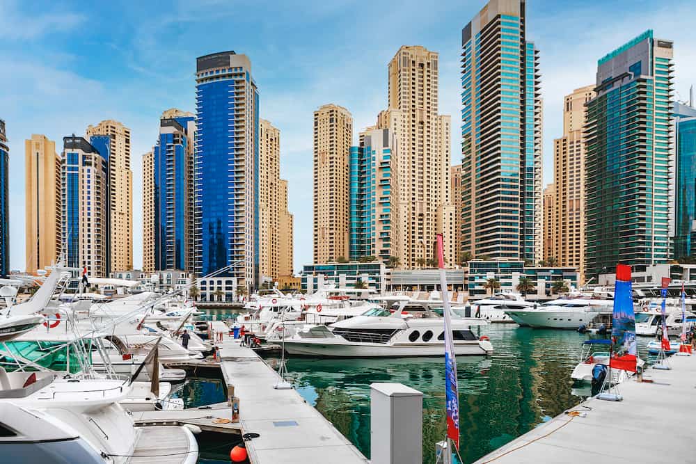 DUBAI, UAE - The promenade of Dubai Marina with the yachts