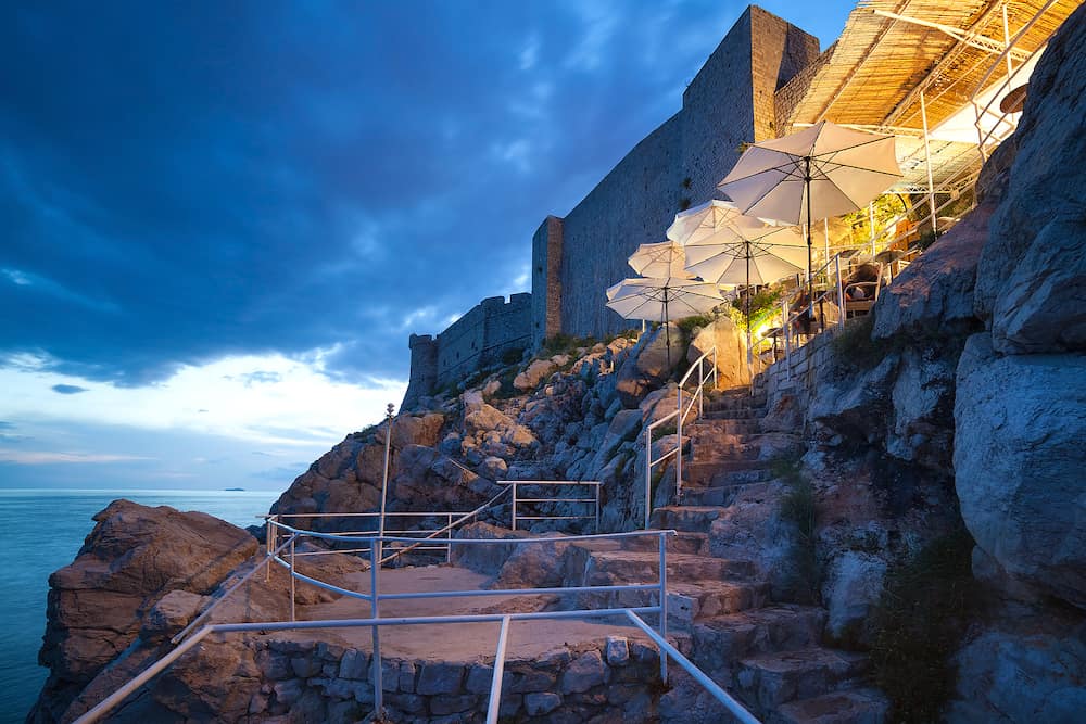 DUBROVNIK, CROATIA - Buza beach cafe at night. It is one of the most beautiful bars in Dubrovnik which is hanged on the cliffs right above the sea, with an amazing view of the Adriatic.